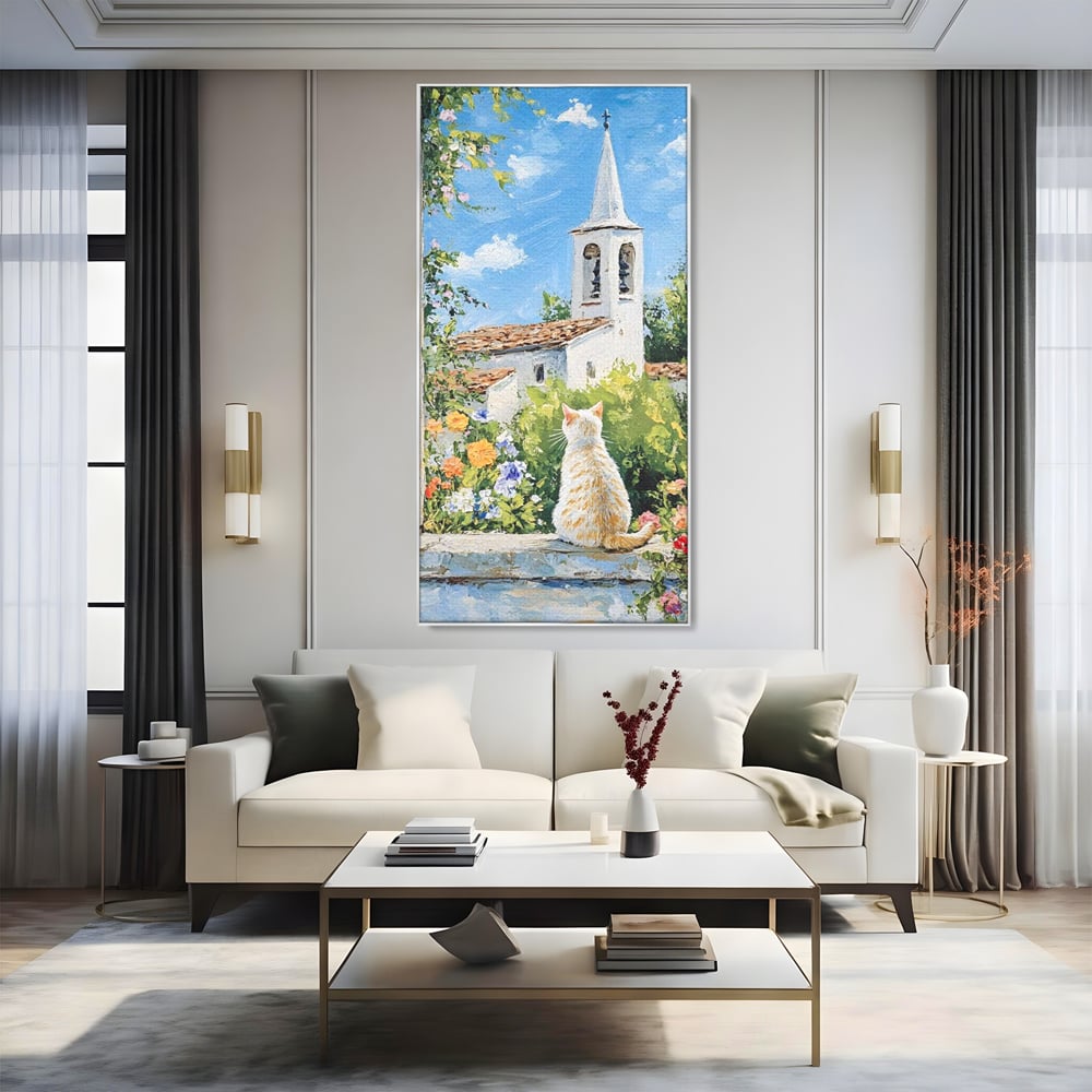 Tablou canvas cu tablou pictura cu pisica alba si biserica, in rama de aluminiu argintiu, pe perete intr-un living